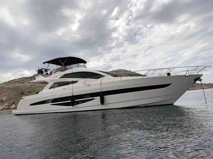  Yacht Photos Pics Luxury 2010 Galeon 700 Raptor SkyDeck yacht on calm water under cloudy sky.