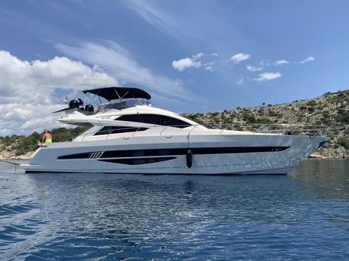  Yacht Photos Pics Luxury 2010 Galeon 700 Raptor SkyDeck yacht on serene blue water.