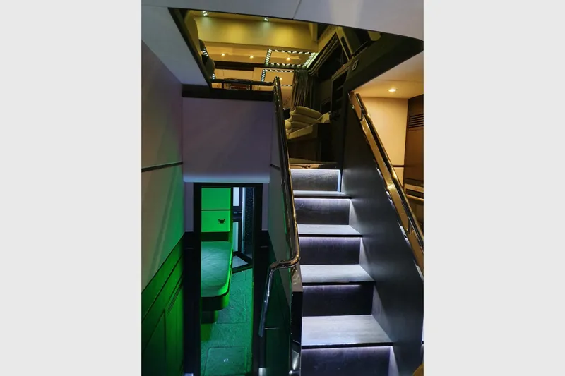  Yacht Photos Pics Interior staircase of 2010 Galeon 700 Raptor SkyDeck yacht, featuring modern design and ambient lighting.