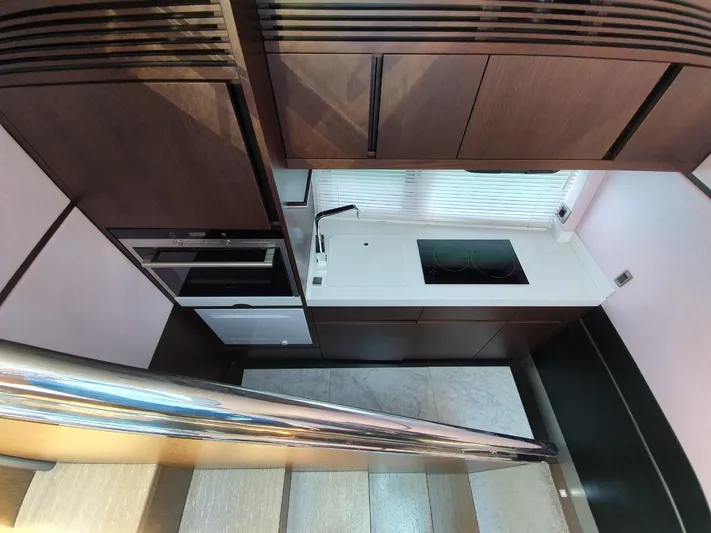  Yacht Photos Pics Modern kitchen interior on 2010 Galeon 700 Raptor SkyDeck yacht, featuring sleek cabinetry and appliances.