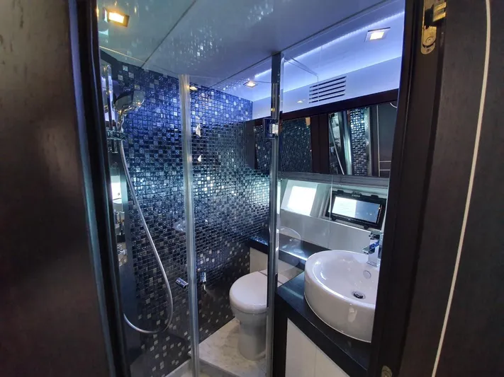  Yacht Photos Pics Luxurious bathroom on 2010 Galeon 700 Raptor SkyDeck yacht with modern fixtures and mosaic tiles.