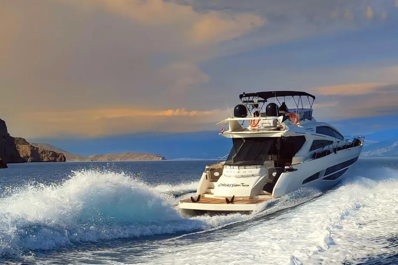  Yacht Photos Pics Galeon 700 Raptor SkyDeck 2010 yacht cruising on open water at sunset.