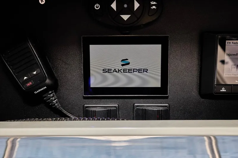  Yacht Photos Pics Control panel of 2022 Bluewater 35 boat featuring Seakeeper and Garmin devices.
