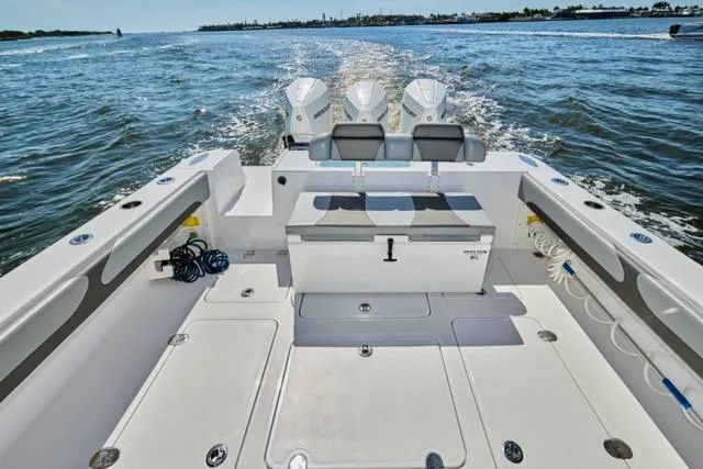  Yacht Photos Pics 2022 Bluewater 35 boat with triple engines cruising on open water.