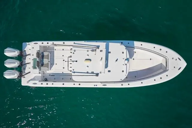  Yacht Photos Pics Aerial view of 2022 Bluewater 35 boat with triple outboard engines on clear water.