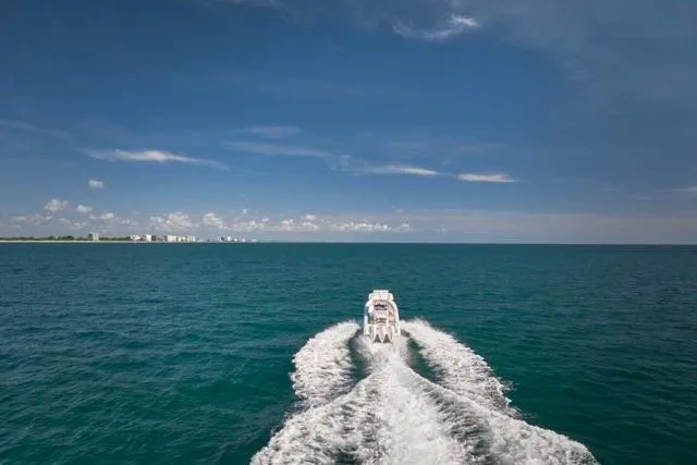  Yacht Photos Pics Bluewater 35 boat cruising on open sea, 2022 model, under clear blue sky.