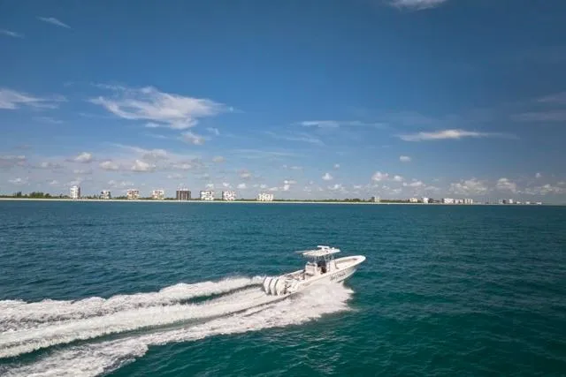  Yacht Photos Pics Bluewater 35 boat cruising on open sea, 2022 model, with coastal skyline in background.