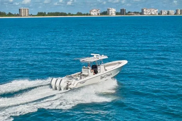  Yacht Photos Pics Bluewater 35 boat cruising on ocean, 2022 model, with city skyline in background.