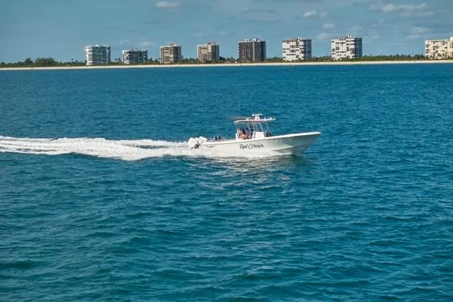  Yacht Photos Pics 2022 Bluewater 35 boat cruising on ocean with city skyline in background.