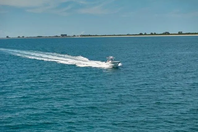  Yacht Photos Pics Bluewater 35 boat cruising on open sea, 2022 model, with distant shoreline.