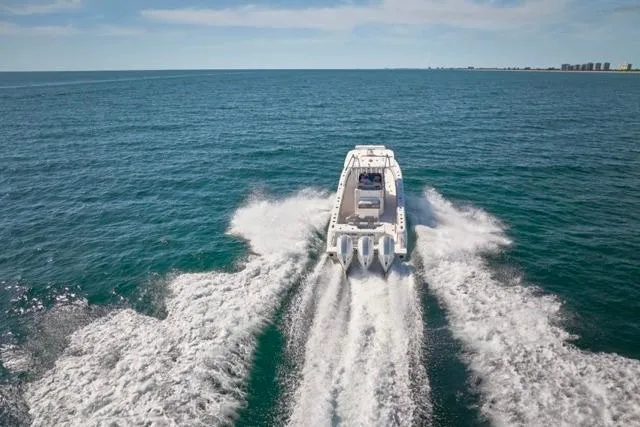  Yacht Photos Pics Bluewater 35 boat cruising on open sea, 2022 model, creating dynamic water trails.