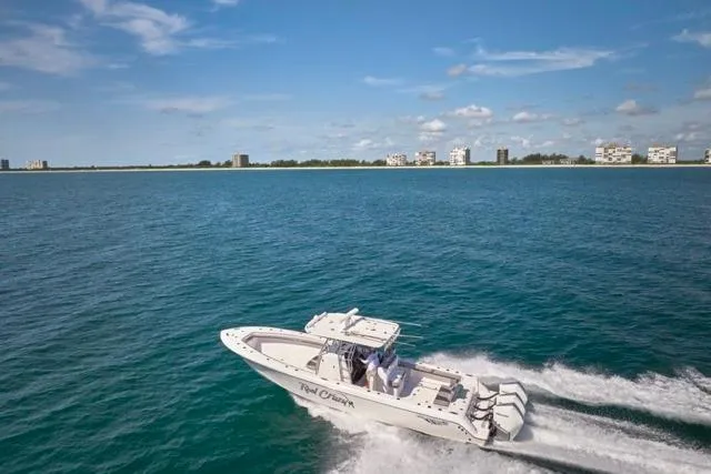  Yacht Photos Pics 2022 Bluewater 35 boat cruising on open water with city skyline in background.