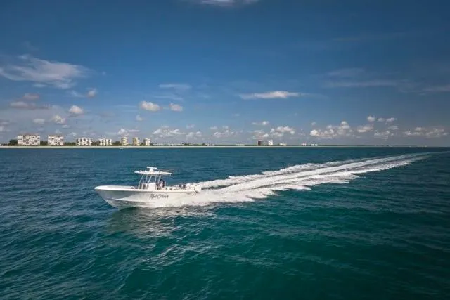  Yacht Photos Pics 2022 Bluewater 35 boat cruising on open sea under clear blue sky.