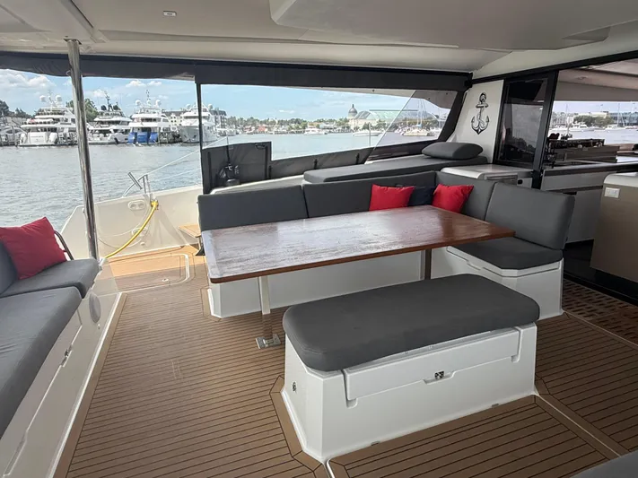 Darla Jay Yacht Photos Pics 2023 Fountaine Pajot Aura 51 yacht interior with elegant seating and wooden table.