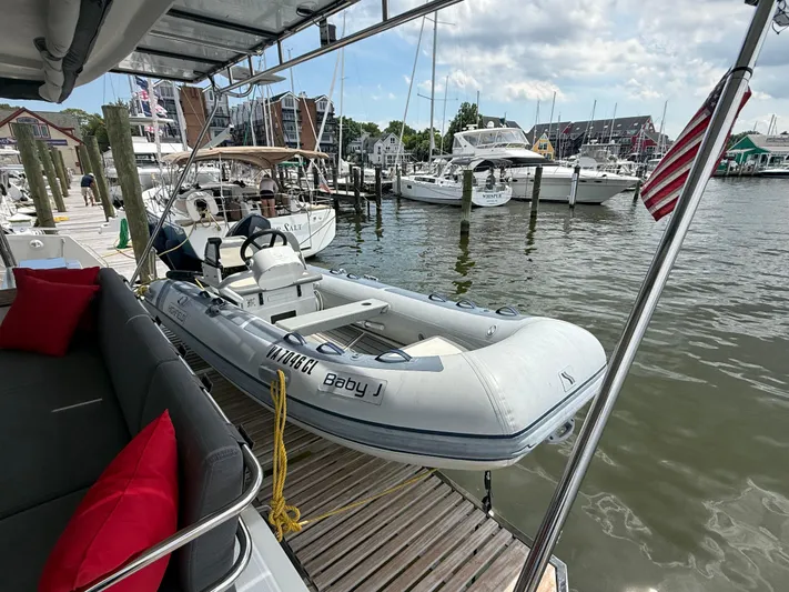 Darla Jay Yacht Photos Pics 2023 Fountaine Pajot Aura 51 yacht docked with inflatable boat, marina view.