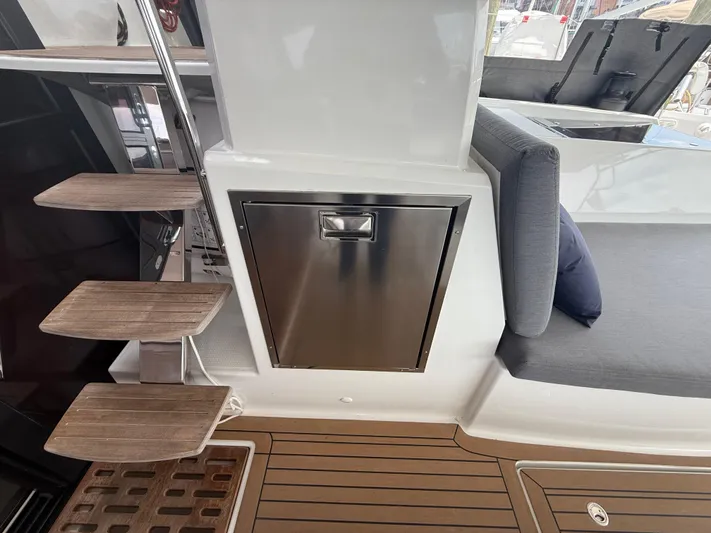 Darla Jay Yacht Photos Pics 2023 Fountaine Pajot Aura 51 yacht interior with wooden steps and stainless steel cabinet.