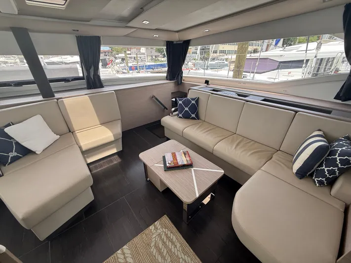 Darla Jay Yacht Photos Pics Luxurious interior of 2023 Fountaine Pajot Aura 51 yacht with elegant seating and decor.