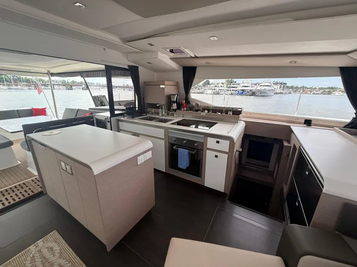 Darla Jay Yacht Photos Pics Luxurious interior of 2023 Fountaine Pajot Aura 51 yacht with modern kitchen and scenic views.