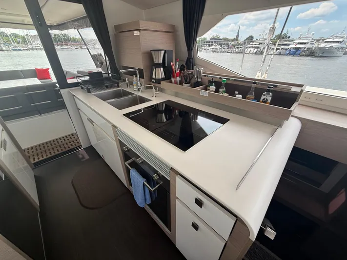 Darla Jay Yacht Photos Pics Modern kitchen interior on 2023 Fountaine Pajot Aura 51 yacht, featuring sleek design and appliances.