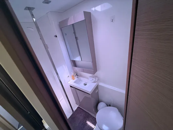 Darla Jay Yacht Photos Pics Modern bathroom in 2023 Fountaine Pajot Aura 51 yacht, featuring sleek design and compact amenities.