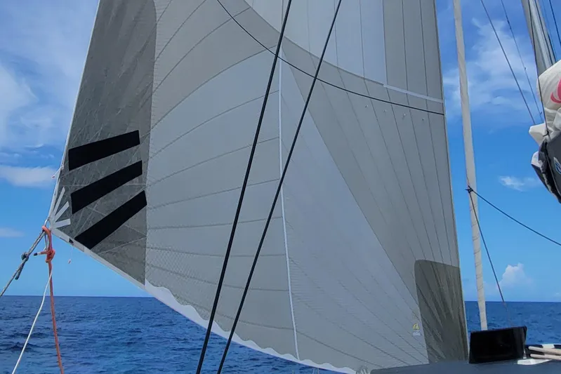 Darla Jay Yacht Photos Pics Sailing on a 2023 Fountaine Pajot Aura 51 catamaran with sails unfurled against a blue sky.