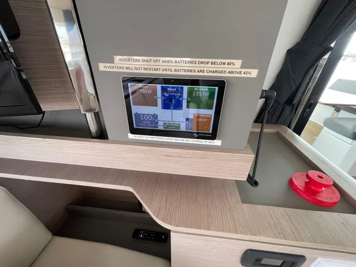 Darla Jay Yacht Photos Pics Control panel on 2023 Fountaine Pajot Aura 51 yacht, displaying battery and inverter status.