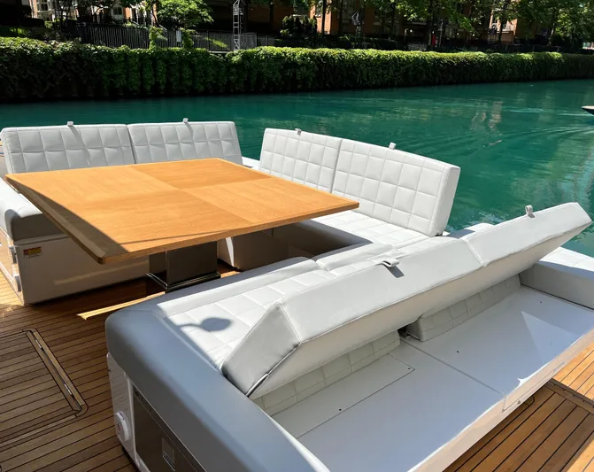  Yacht Photos Pics 2026 Pardo Yachts GT52 deck with elegant seating and wooden table by the water.