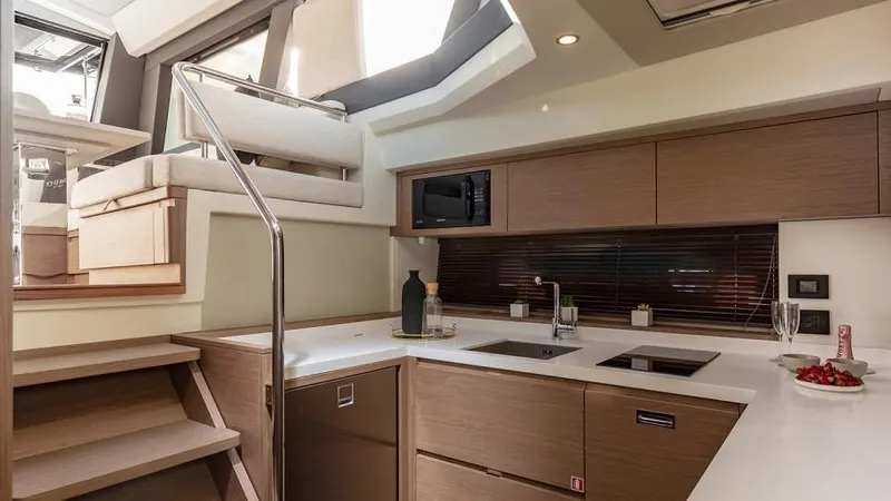  Yacht Photos Pics Modern kitchen interior of 2026 Pardo Yachts GT52 with sleek cabinetry and stairs.