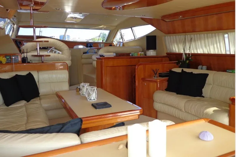  Yacht Photos Pics Luxurious interior of a 2003 Ferretti Yachts 620 with elegant seating and wooden finishes.