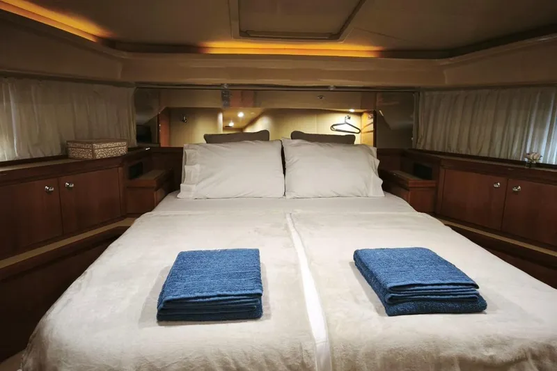  Yacht Photos Pics Luxurious bedroom interior of 2003 Ferretti Yachts 620 with neatly folded towels.