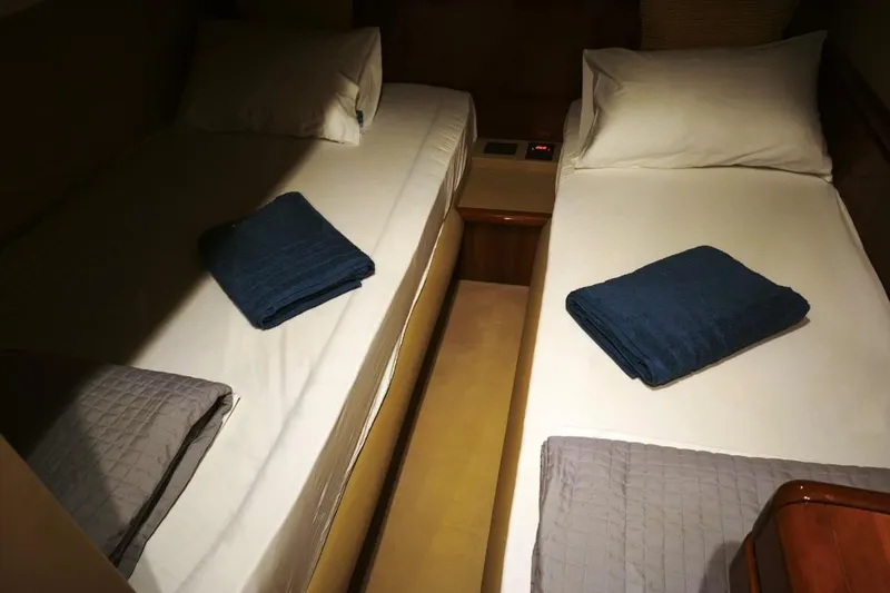  Yacht Photos Pics Twin beds in a 2003 Ferretti Yachts 620 cabin, neatly arranged with folded towels.