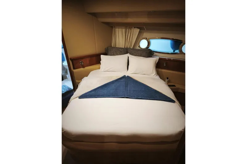  Yacht Photos Pics Luxurious bedroom interior of 2003 Ferretti Yachts 620 with neatly arranged bed linens.