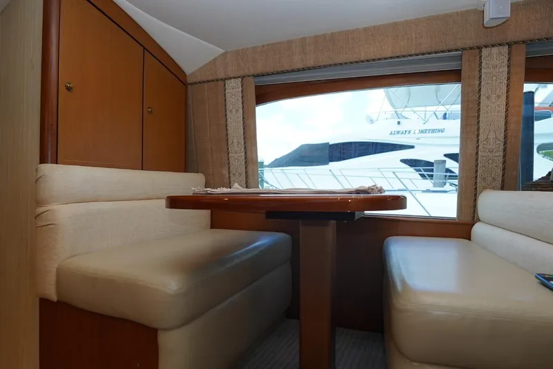 Etan Yacht Photos Pics Interior of 2005 Ocean Yachts 50 Super Sport with dining area and window view.