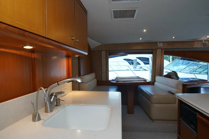 Etan Yacht Photos Pics Luxurious interior of 2005 Ocean Yachts 50 Super Sport with modern kitchen and seating area.