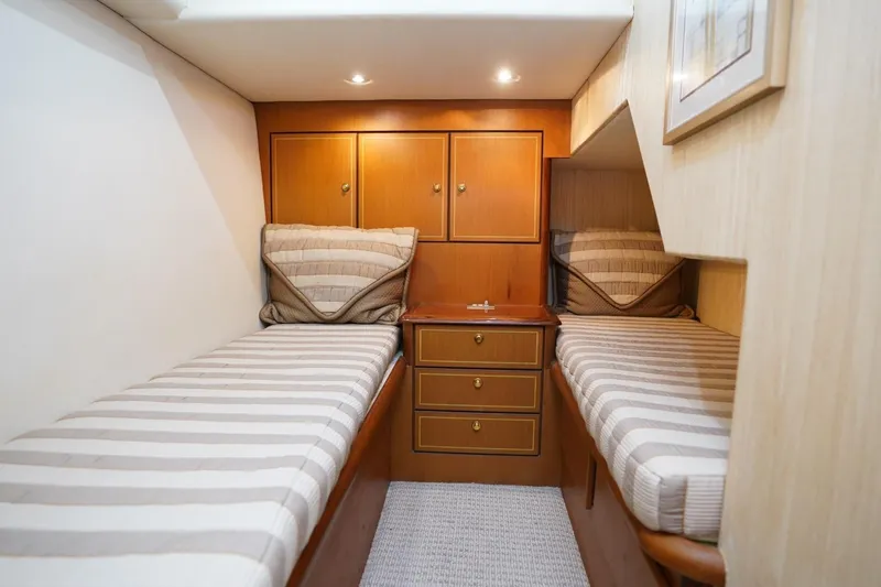 Etan Yacht Photos Pics 2005 Ocean Yachts 50 Super Sport cabin with twin beds and wooden cabinetry.