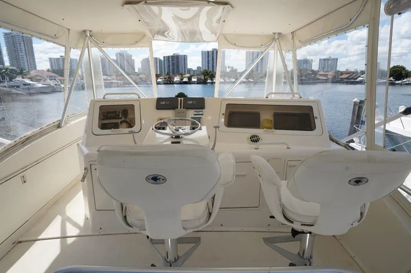 Etan Yacht Photos Pics 2005 Ocean Yachts 50 Super Sport helm with marina view, featuring dual captain chairs.