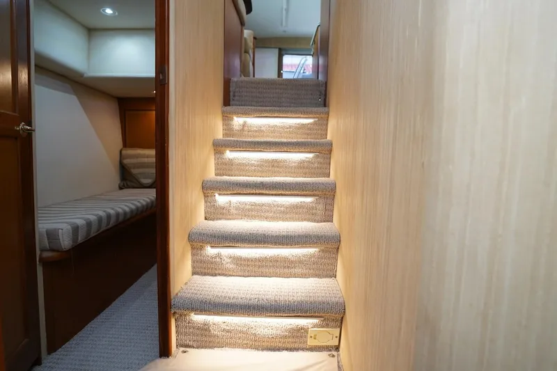 Etan Yacht Photos Pics Carpeted stairs with lighting in a 2005 Ocean Yachts 50 Super Sport interior.
