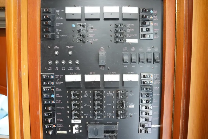 Etan Yacht Photos Pics Electrical panel of a 2005 Ocean Yachts 50 Super Sport boat, featuring various switches and controls.