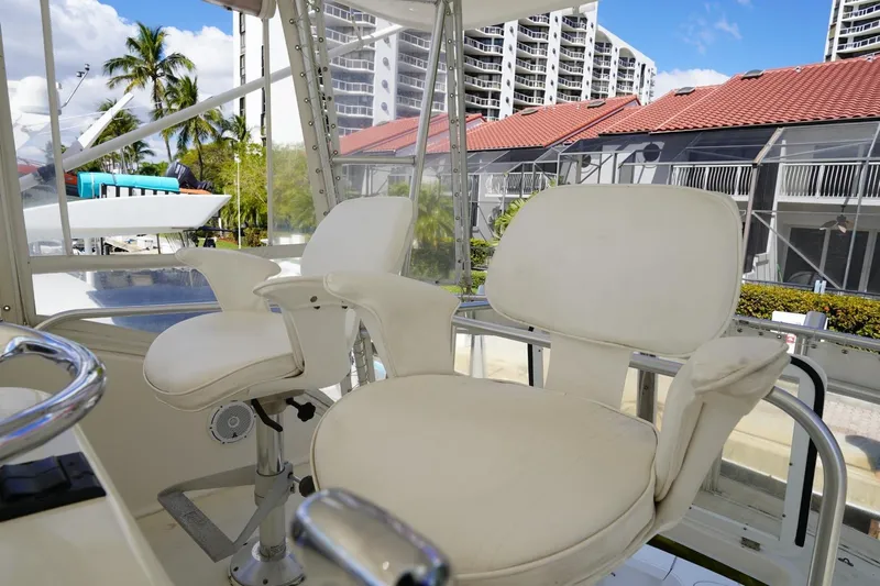 Etan Yacht Photos Pics Captain's chairs on 2005 Ocean Yachts 50 Super Sport, with marina and buildings in background.