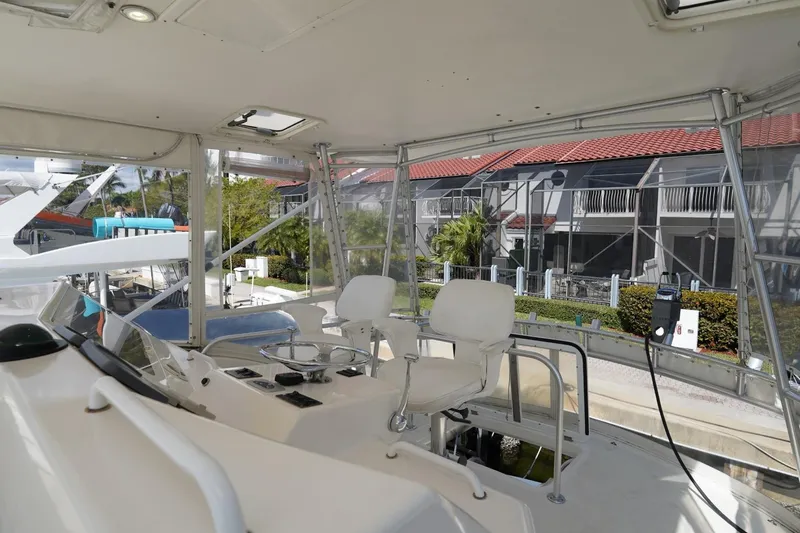 Etan Yacht Photos Pics 2005 Ocean Yachts 50 Super Sport helm with dual seats and marina view.