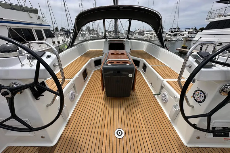  Yacht Photos Pics 2018 Jeanneau 54 yacht cockpit with dual steering wheels and teak flooring at marina.