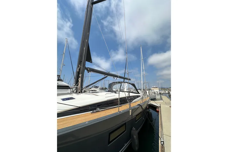  Yacht Photos Pics 2018 Jeanneau 54 yacht docked at marina under blue sky.