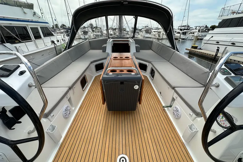  Yacht Photos Pics Luxurious 2018 Jeanneau 54 yacht cockpit with spacious seating and elegant wood flooring.