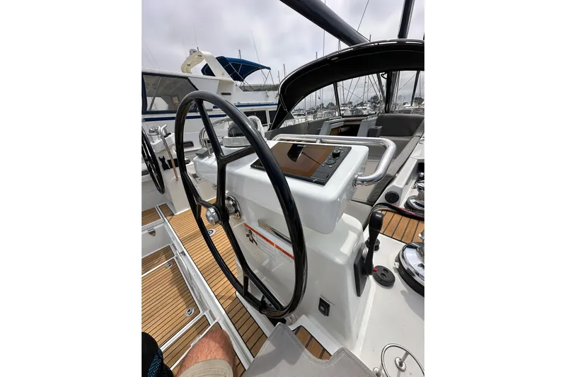  Yacht Photos Pics Steering wheel and controls of a 2018 Jeanneau 54 yacht, featuring sleek design and wood accents.
