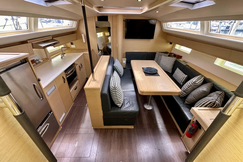  Yacht Photos Pics Luxurious interior of a 2018 Jeanneau 54 yacht with modern kitchen and cozy seating area.