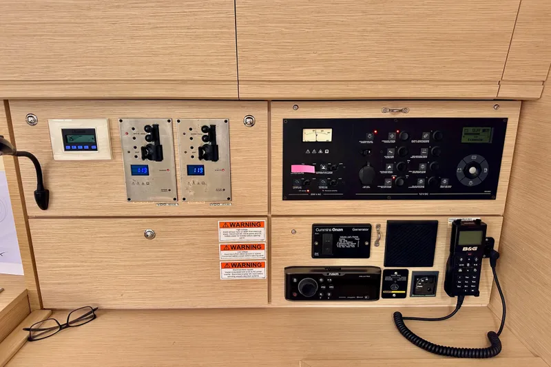  Yacht Photos Pics Control panel of a 2018 Jeanneau 54 yacht with various instruments and warning labels.