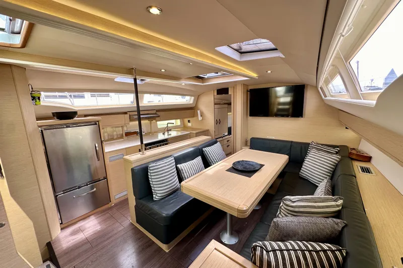  Yacht Photos Pics Luxurious interior of a 2018 Jeanneau 54 yacht with modern kitchen and cozy seating area.