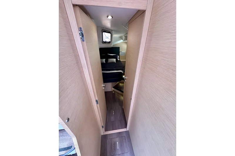  Yacht Photos Pics Narrow hallway leading to a cozy cabin in a 2018 Jeanneau 54 yacht.
