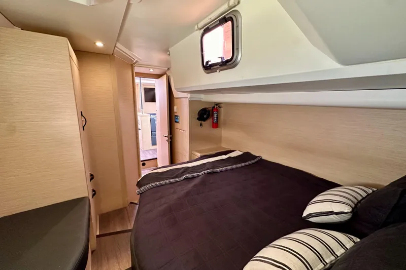  Yacht Photos Pics Luxurious cabin interior of 2018 Jeanneau 54 yacht with cozy bedding and modern design.