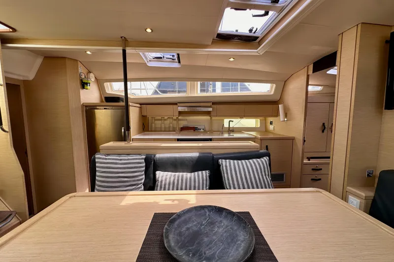  Yacht Photos Pics Luxurious interior of 2018 Jeanneau 54 yacht with modern kitchen and dining area.